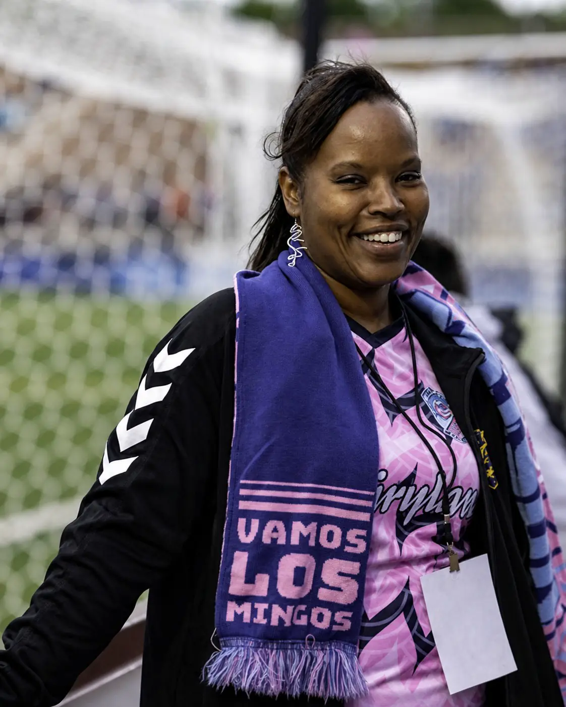 April Kigeya smiling at a community soccer event